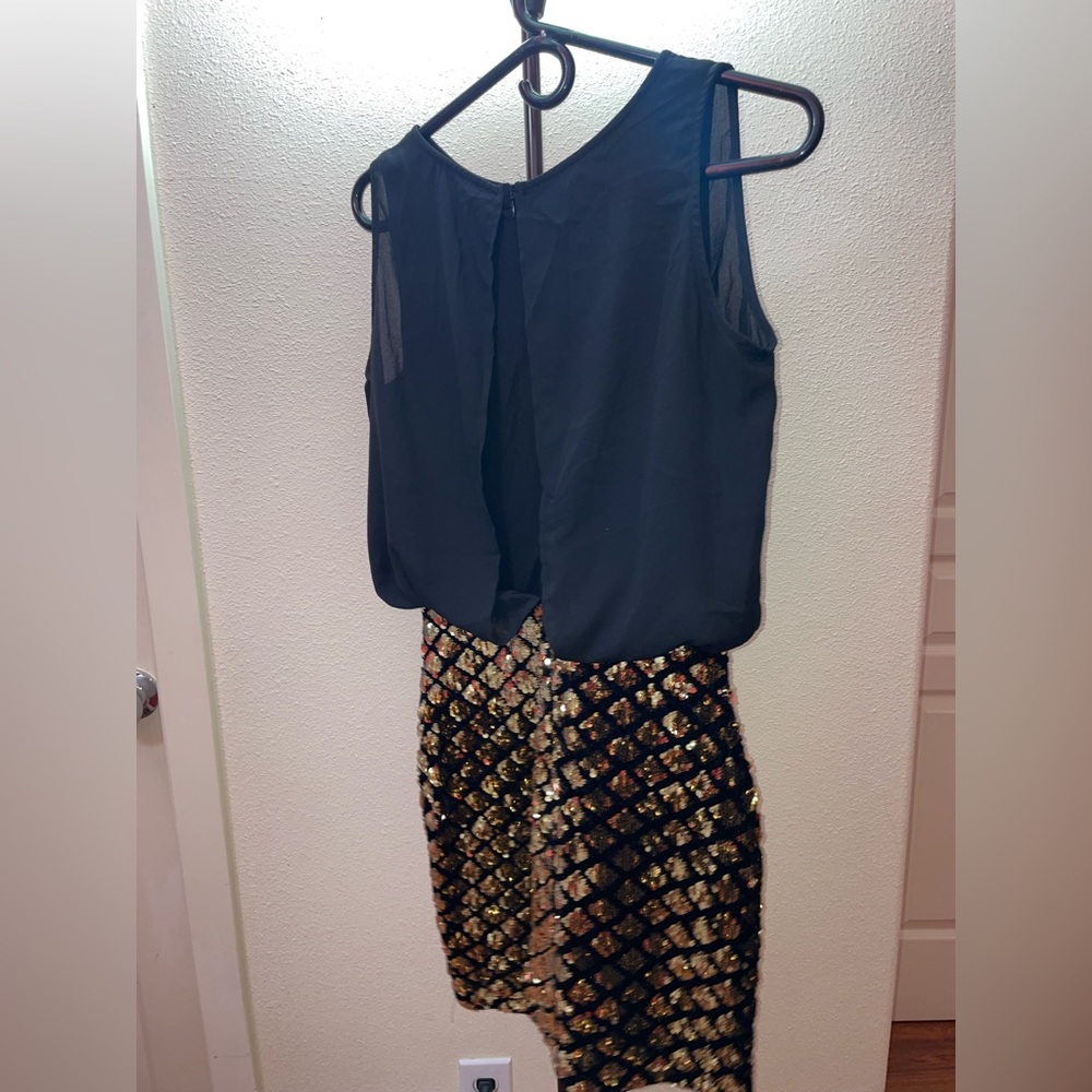 Short blacks dress with gold skirt.